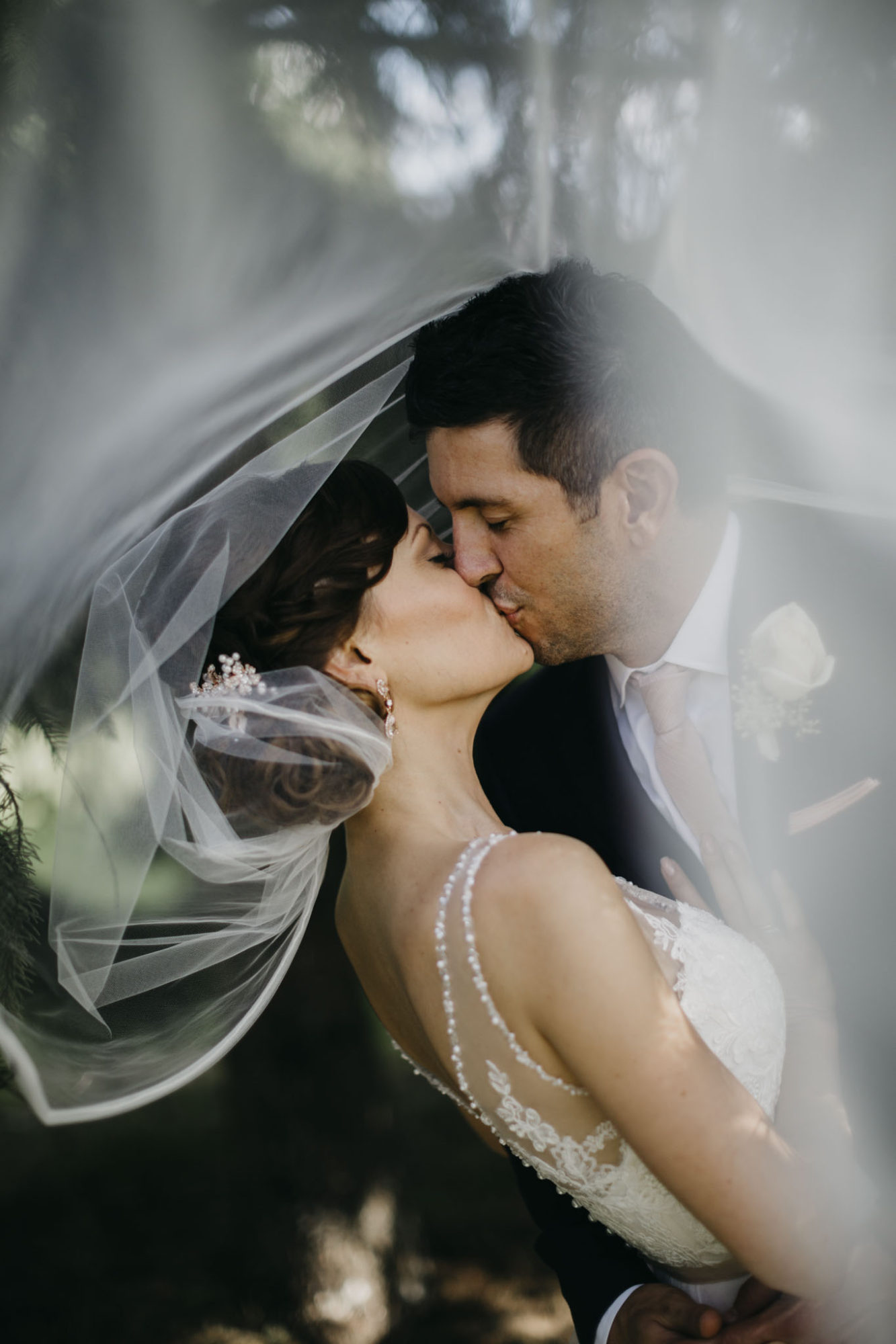 Bride and groom kissing at Starry Night Barn and Studios Wedding