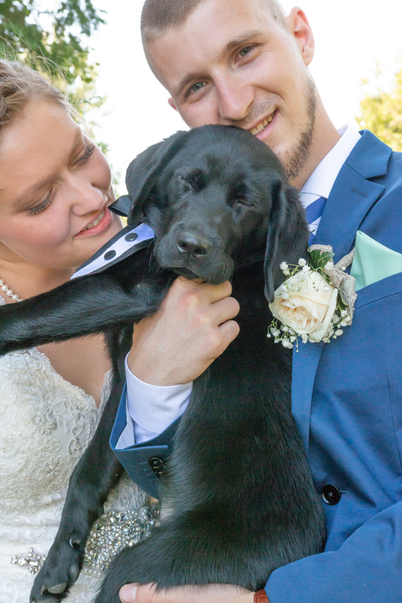 Married couple with puppy at Starry Night Barn and Studios Wedding