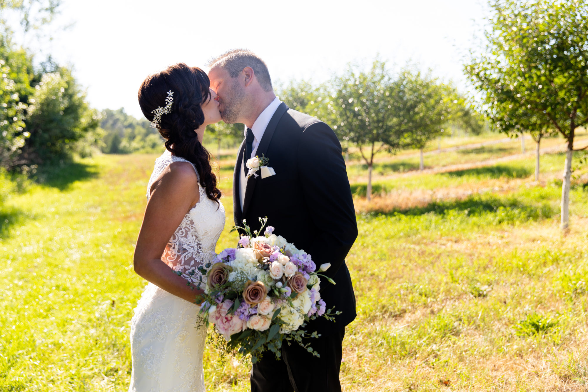Married couple kiss at Starry Night Barn and Studios Wedding